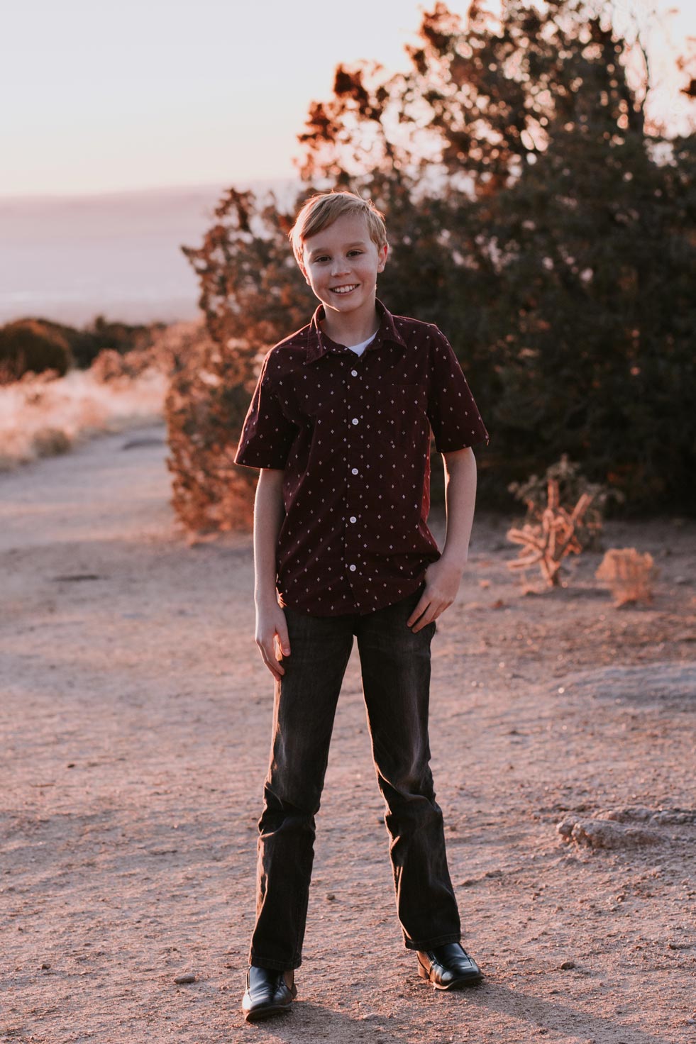 Smiling boy in front of sunset in Albuquerque, NM