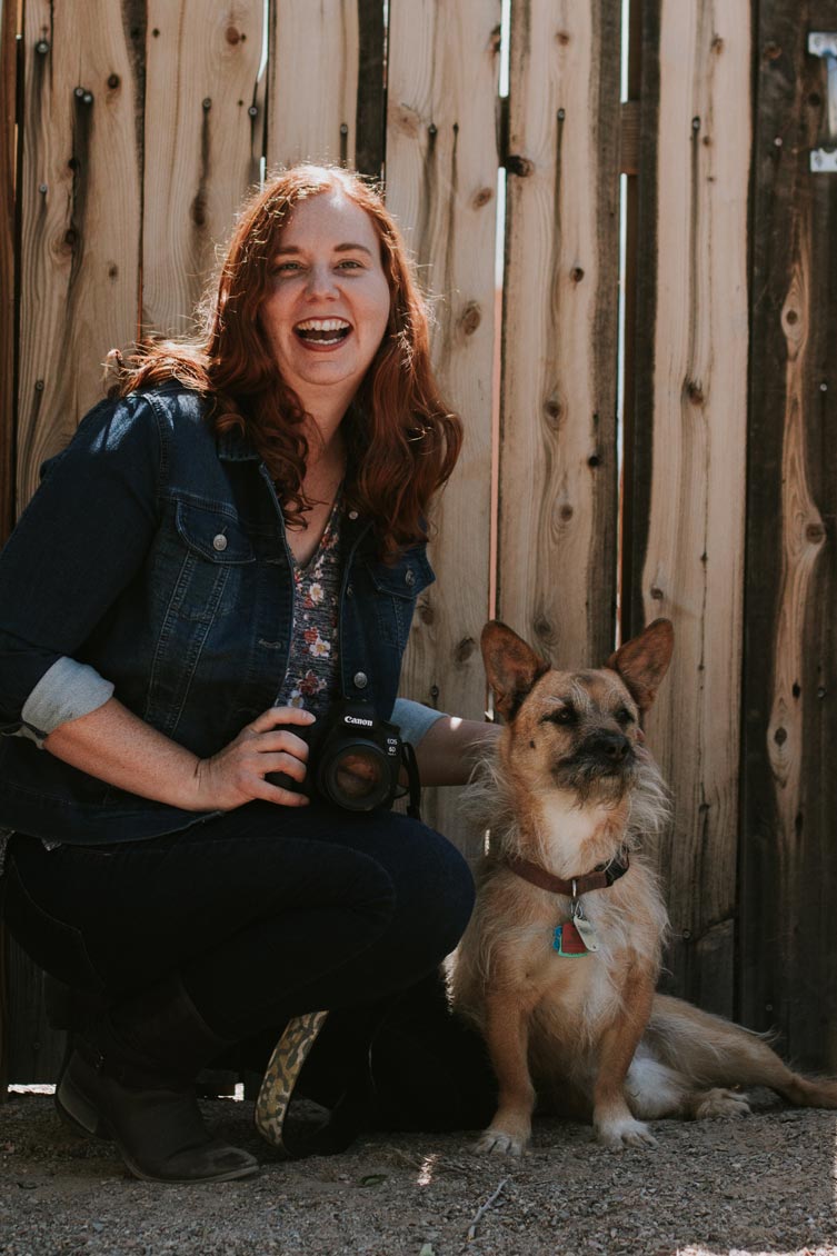 New Mexico photographer Anna Cummings laughing with camera and her dog